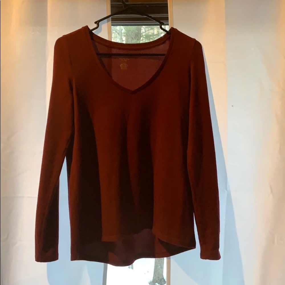 Long sleeve maroon t-shirt.